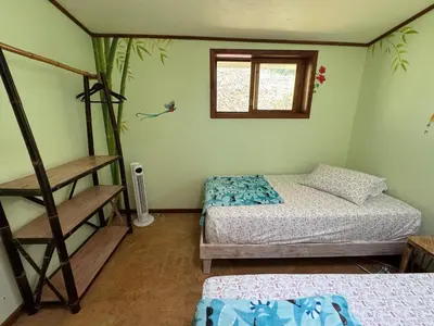 a room with two bunk beds and a window at Finca Renacer - Jungle Lodges in San Luis