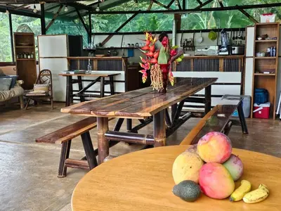a wooden table with a bunch of fruit on it at Finca Renacer - Jungle Lodges in San Luis