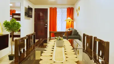 a living room with a table with pillows on it at Casa Sambola in Tortuguero