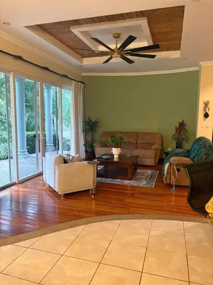 a living room with a couch and a ceiling fan at Casa Esperanza Luxury Villa in Esterillos Este