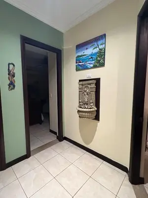 a room with a fireplace and a picture on the wall at Casa Esperanza Luxury Villa in Esterillos Este
