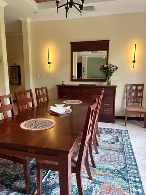 a dining room with a wooden table and a mirror at Casa Esperanza Luxury Villa in Esterillos Este