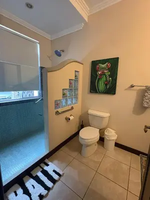a bathroom with a shower and a toilet and a glass shower at Casa Esperanza Luxury Villa in Esterillos Este