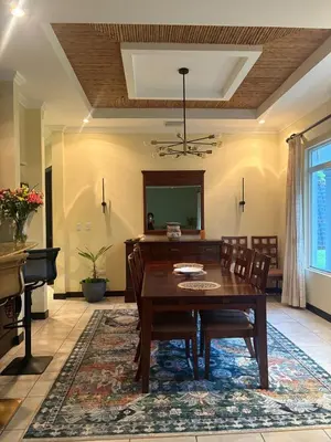 a dining room with a table and a piano at Casa Esperanza Luxury Villa in Esterillos Este