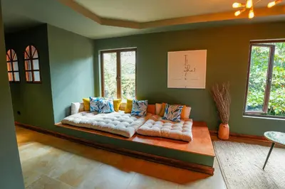 a living room with a couch in the corner at Private Wellness Home Sauna, Jacuzzi &Cold Plunge in Brasil