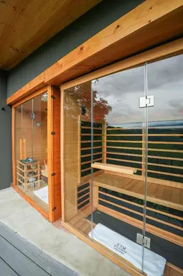 a room with glass windows on the side of a house at Private Wellness Home Sauna, Jacuzzi &Cold Plunge in Brasil