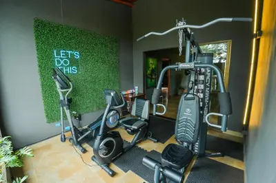 a gym with two treadmills and two exercise bikes at Private Wellness Home Sauna, Jacuzzi &Cold Plunge in Brasil