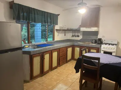 a kitchen with a table and a counter top at Casitas Diquis in Ojochal