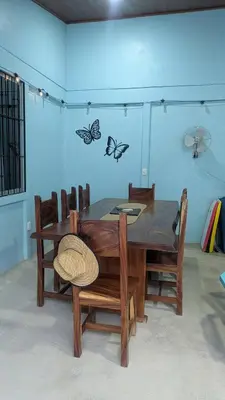 a dining room table and chairs with butterflies on the wall at Casa Azul Tropical Poolside Oasis in Sámara in Sámara