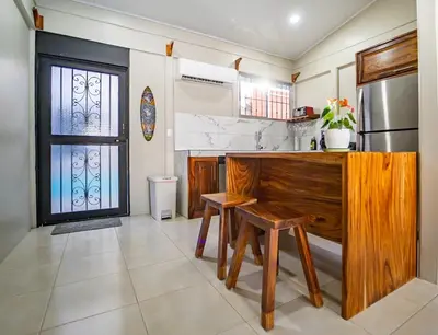 a kitchen with a wooden counter and a refrigerator at Casa Azul Tropical Poolside Oasis in Sámara in Sámara