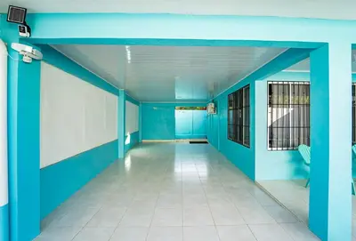 an empty hallway in a hospital with blue walls at Casa Azul Tropical Poolside Oasis in Sámara in Sámara