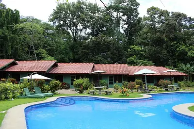 a resort with a large pool in front of it at Hacienda Baru in Dominical