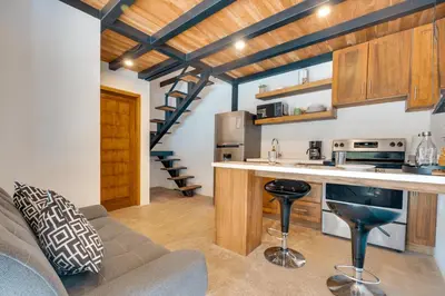 a living room with a couch and a kitchen at 5 Lofts En La Paraiso in Playa Grande