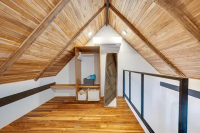 an attic hallway with a wooden ceiling and wood floors at 5 Lofts En La Paraiso in Playa Grande