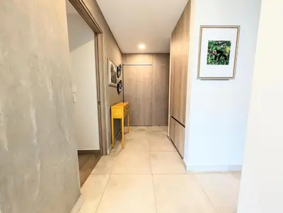 a hallway with a door and a yellow table at Torres del Mar rainforest-view two-bedroom condo in Jacó