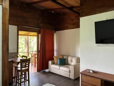 a living room with a couch and a table at Villas El Silencio - Las Tierras de Leonor in San Juanillo