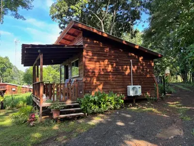 a small log cabin with a porch and a porch at Villas El Silencio - Las Tierras de Leonor in San Juanillo