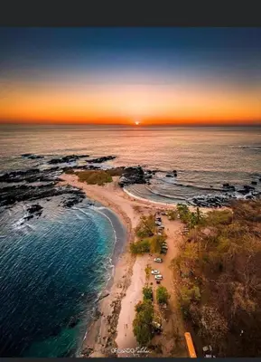 an aerial view of a beach at sunset at Villas El Silencio - Las Tierras de Leonor in San Juanillo