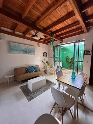 a living room with a table and a couch at Casa Corazón in Cóbano