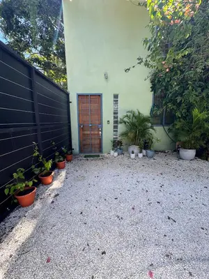 a house with potted plants in front of a door at Casa Corazón in Cóbano
