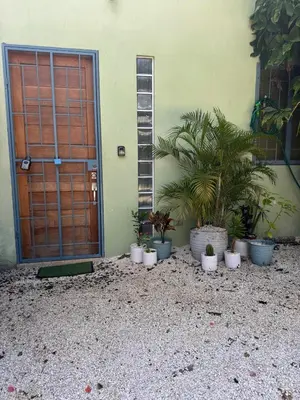 a door to a house with potted plants in front of it at Casa Corazón in Cóbano