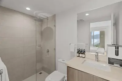 a bathroom with a shower and a sink and a toilet at Oceanfront 3-BR Condo with Stunning Views in Jacó