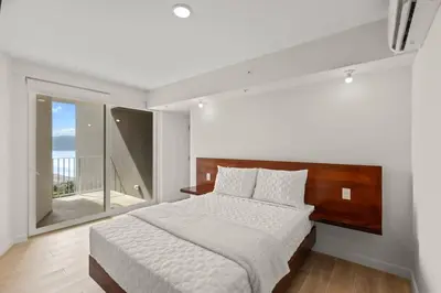a bedroom with a large bed and a balcony at Oceanfront 3-BR Condo with Stunning Views in Jacó