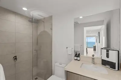 a bathroom with a shower and a toilet and a sink at Oceanfront 3-BR Condo with Stunning Views in Jacó