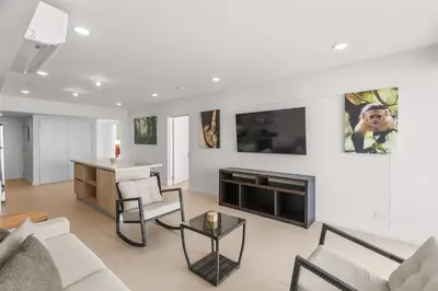 a living room with a couch and a tv at Oceanfront 3-BR Condo with Stunning Views in Jacó