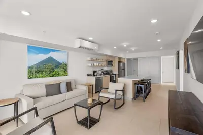 a living room with a couch and a table at Oceanfront 3-BR Condo with Stunning Views in Jacó