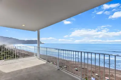 a view of the ocean from the balcony of a house at Oceanfront 3-BR Condo with Stunning Views in Jacó