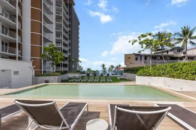 a swimming pool with lounge chairs in a building at Oceanfront 3-BR Condo with Stunning Views in Jacó
