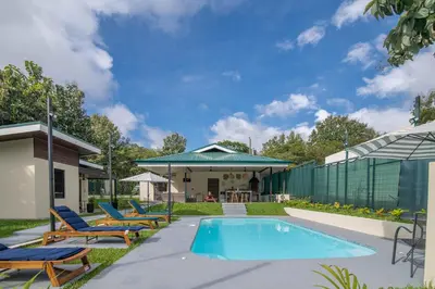 a swimming pool with lounge chairs and a house at Casa do Mar in Cebadilla