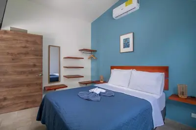 a bedroom with a bed with a blue wall at Casa do Mar in Cebadilla