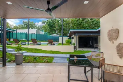 an outdoor patio with a table and a ceiling fan at Casa do Mar in Cebadilla