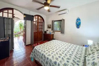 a bedroom with a bed and a ceiling fan at Villas El Parque 18B Central Studio Apartment in Quepos