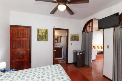 a bedroom with a bed and a ceiling fan at Villas El Parque 18B Central Studio Apartment in Quepos