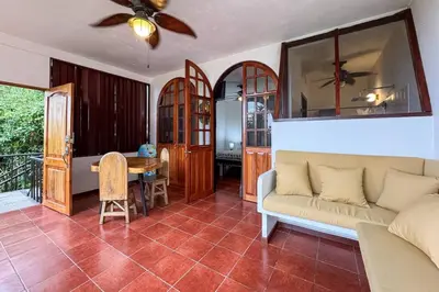 a living room with a couch and a table at Villas El Parque 18B Central Studio Apartment in Quepos