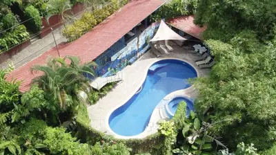 an overhead view of a swimming pool with trees at Villas el Parque 18A 1BR Central Apartment w Huge Patio in Quepos
