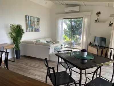 a living room with a table and a couch at Palco Pacífico Villa with Private Rooftop Pool in Alto del Monte