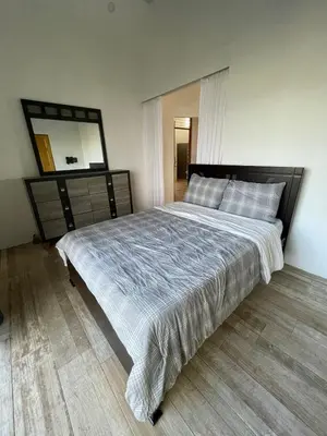 a bedroom with a large bed and a mirror at Palco Pacífico Villa with Private Rooftop Pool in Alto del Monte