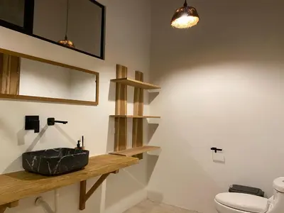 a bathroom with a sink and a toilet at Private rainforest villa up to 8 guests w jacuzzi near Rio Celeste in Upala
