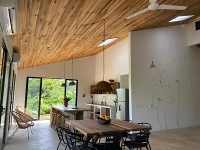 a kitchen and dining room with a wooden ceiling at Private rainforest villa up to 8 guests w jacuzzi near Rio Celeste in Upala