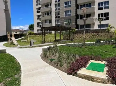 a park in front of a building with a playground at Charming Apartment in Curridabat in Granadilla