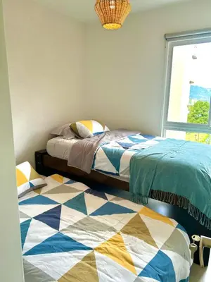 a bedroom with two beds and a window at Charming Apartment in Curridabat in Granadilla
