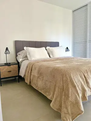 a bedroom with a large bed and a window at Charming Apartment in Curridabat in Granadilla