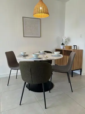 a dining room table with chairs and a chandelier at Charming Apartment in Curridabat in Granadilla