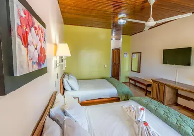 a hospital room with two beds and a television at Hotel Manuel Antonio in Manuel Antonio
