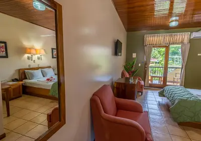 a bedroom with a bed and a mirror at Hotel Manuel Antonio in Manuel Antonio