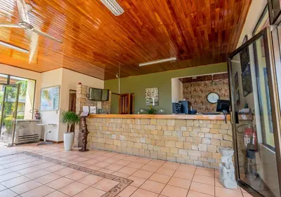 a room with a counter and a brick wall at Hotel Manuel Antonio in Manuel Antonio